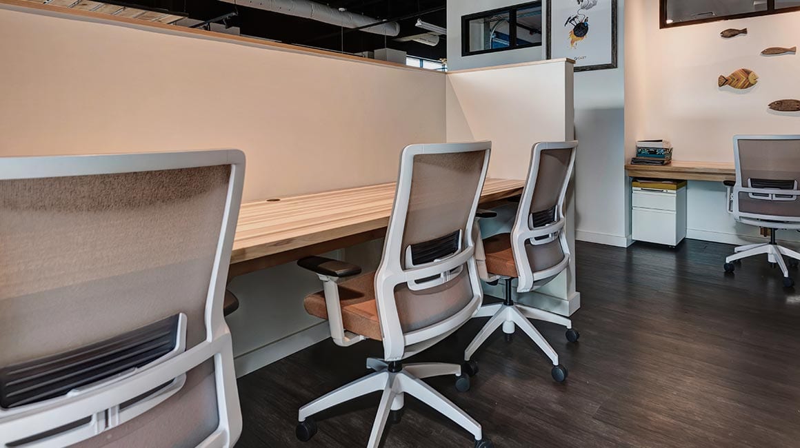 brown rolling office chairs against wooden desk space